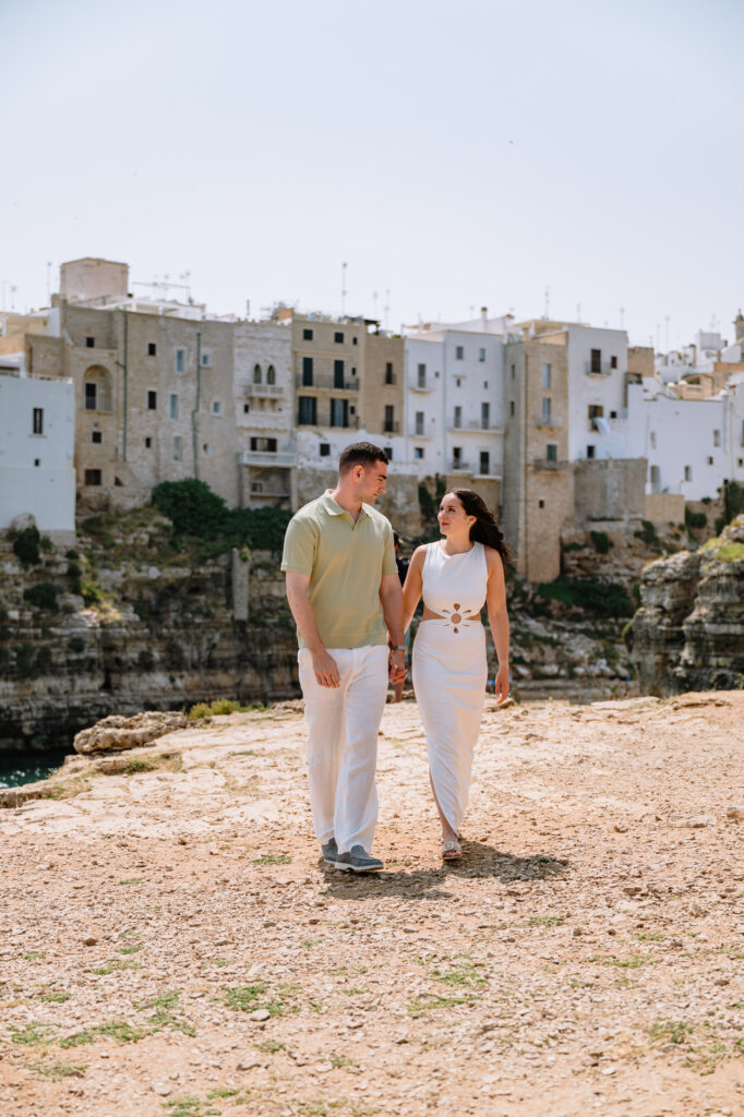 Romantic couple on cliffside in Puglia, Italy