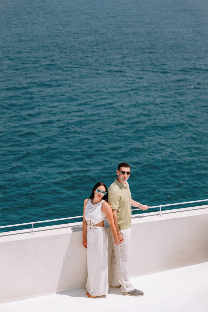 Emotional couple hugging after proposal in Polignano