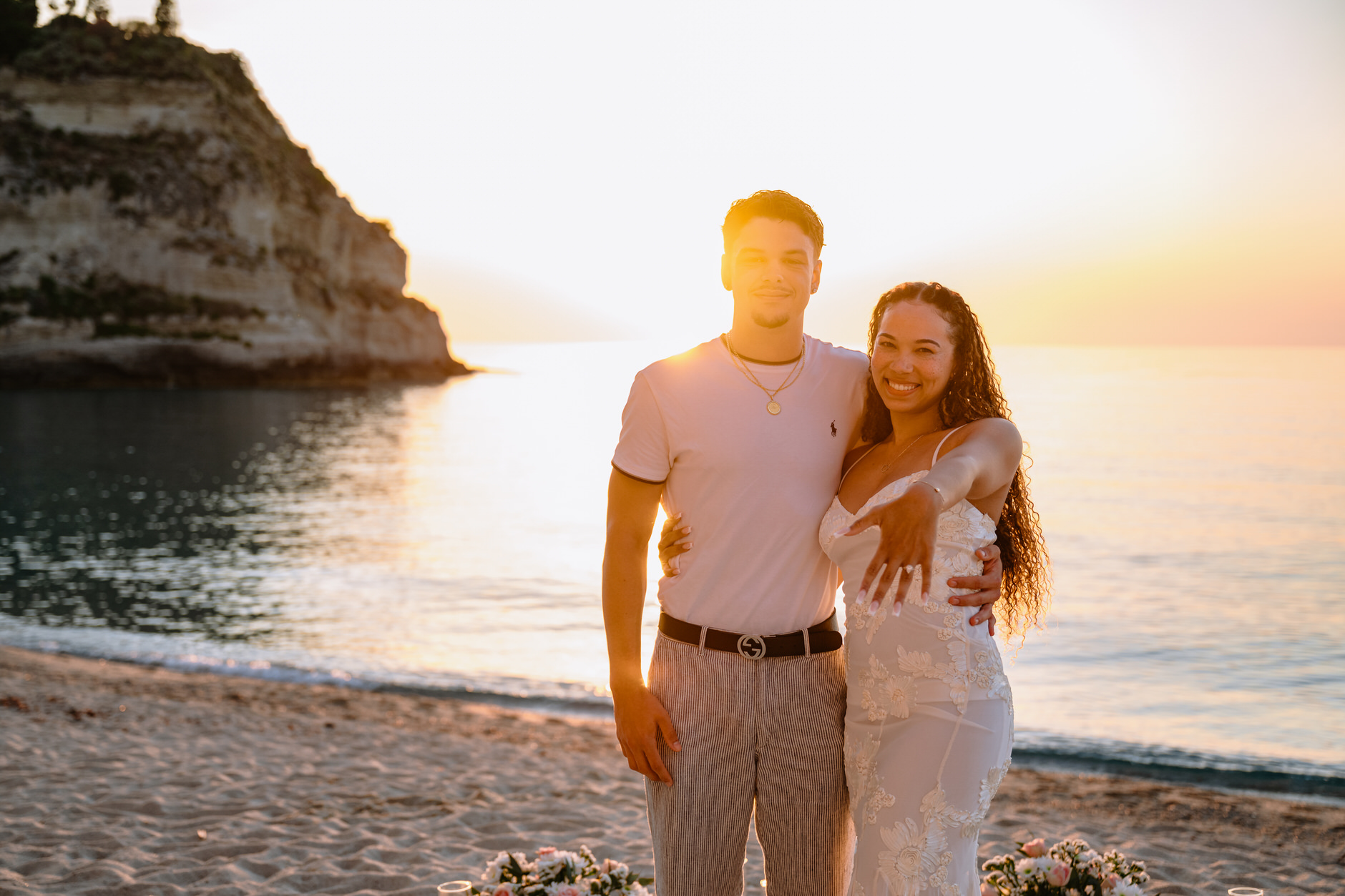 Portrait of an engaged couple smiling on the beach in Tropea Italy