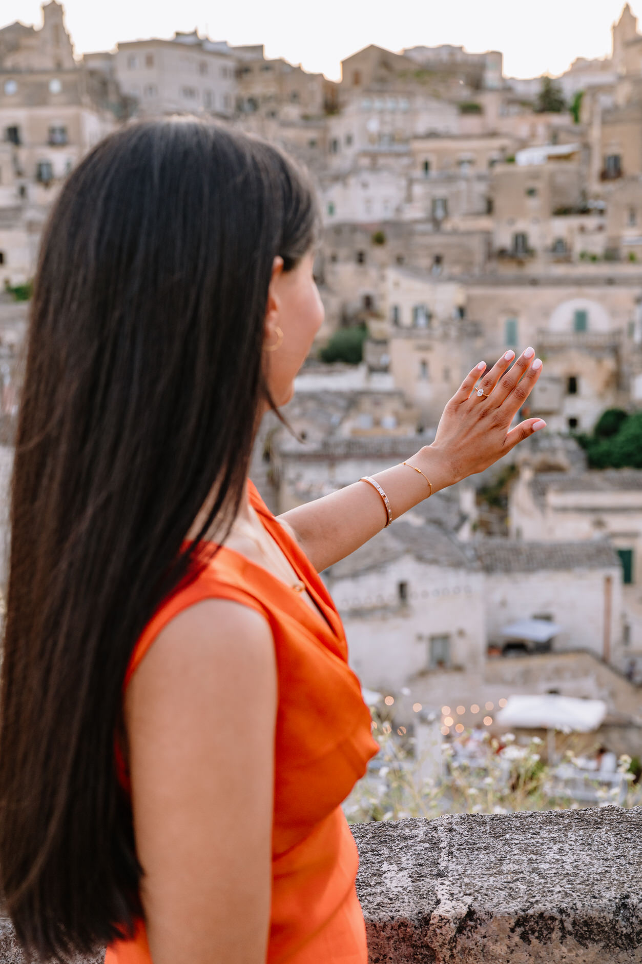 girl watching at her engagement ring with matera in the background