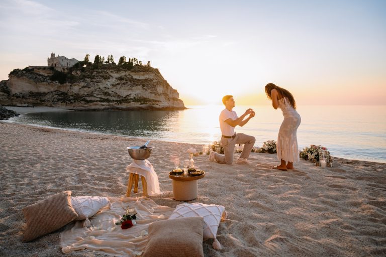 Emotional reaction of a woman during a sunset proposal on the coast of Tropea